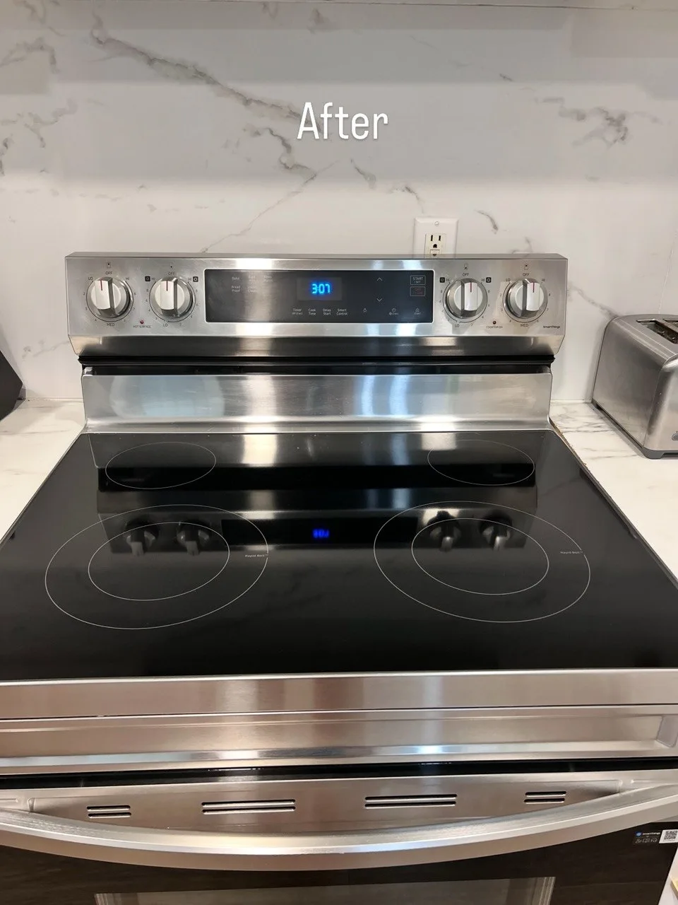 Black glass-top range and stainless steel controls after cleaning